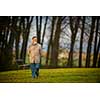 Portrait of a senior man outdoors, walking in a park (shallow DOF; color toned image)