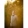 Portrait of a senior man outdoors, walking in a park, full lenght portrait (shallow DOF; color toned image)