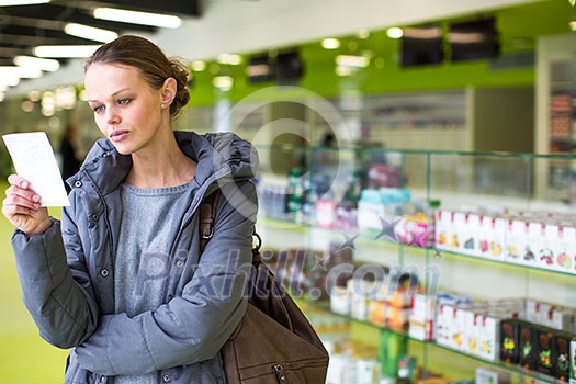 Young woman looking for the right pills in a modern pharmacy (shallow DOF; color toned image) Young woman looking for the right pills in a modern pharmacy (shallow DOF; color toned image)