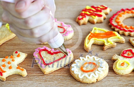 Decorating homemade shortbread cookies with icing from piping bag Decorating homemade shortbread cookies with icing from piping bag