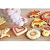 Decorating homemade shortbread cookies with icing from piping bag