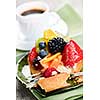 Fresh mixed berry tart served with coffee for dessert