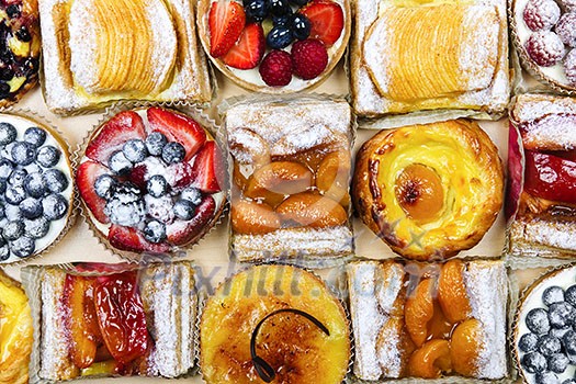 Background of assorted fresh sweet tarts and pastries from above Background of assorted fresh sweet tarts and pastries from above