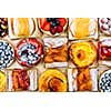 Background of assorted fresh sweet tarts and pastries from above