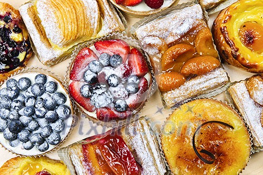 Background of assorted fresh sweet tarts and pastries from above Background of assorted fresh sweet tarts and pastries from above