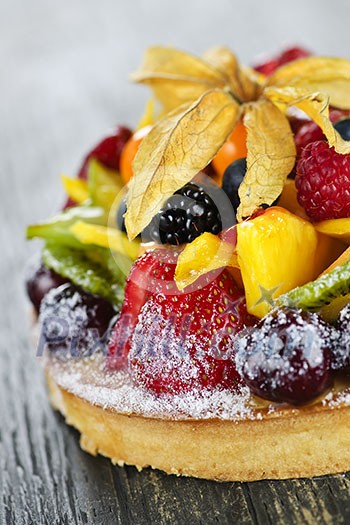 Fresh dessert fruit tart covered in assorted tropical fruits Fresh dessert fruit tart covered in assorted tropical fruits