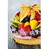 Fresh dessert fruit tart covered in assorted tropical fruits