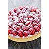 Fresh dessert fruit tart covered in raspberries