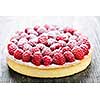 Fresh dessert fruit tart covered in raspberries