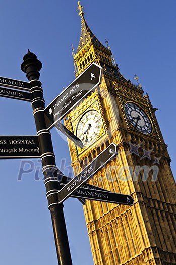 Big Ben clock tower with signpost in London Big Ben clock tower with signpost in London