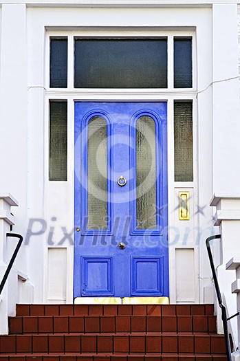 Blue front door with brass knocker in London England Blue front door with brass knocker in London England