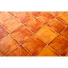 Closeup of square terracotta ceramic tile floor background