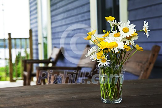 Bouquet of wildflowers on a rustic table at country cottage Bouquet of wildflowers on a rustic table at country cottage
