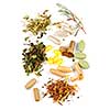 Herbs,  herbal supplements and vitamin pills on white background