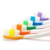 Close up of multicolored toothbrushes on white background