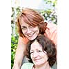 Family portrait of smiling mature mother and daughter