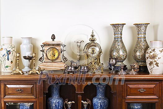 Various antique clocks vases and candlesticks on display Various antique clocks vases and candlesticks on display