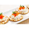 Closeup of caviar and cream cheese appetizer on crackers