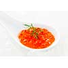 Closeup of caviar with dill garnish in white spoon on ice