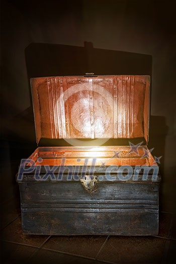 Antique wooden chest with open lid and light inside