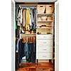 Clothes hung neatly in organized closet at home