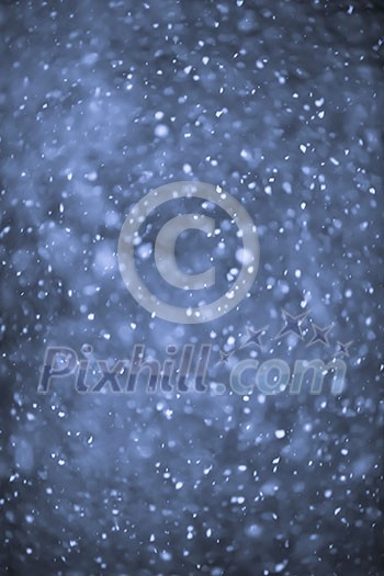 Background of snow flurry falling at night with motion blur Background of snow flurry falling at night with motion blur