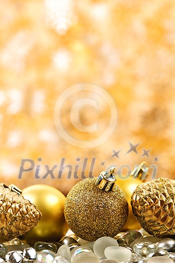 Golden Christmas background with ornaments and pine cones Golden Christmas background with ornaments and pine cones
