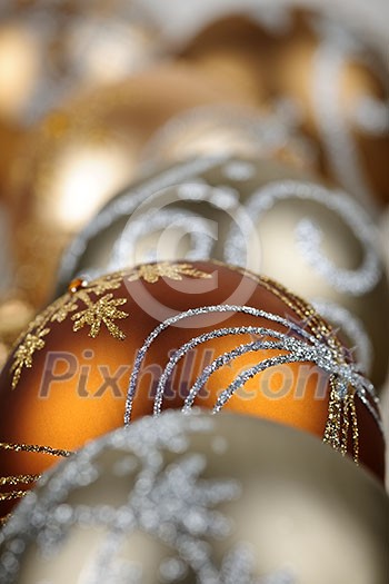 Closeup of golden Christmas balls with festive designs Closeup of golden Christmas balls with festive designs
