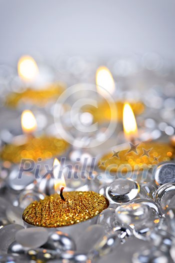 Burning golden decorative Christmas candles with glass beads Burning golden decorative Christmas candles with glass beads