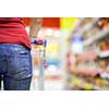 Young woman grocery shopping in supermarket