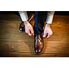 Handsome groom on his wedding day - tying a shoe lace