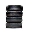 Stack of brand new high performance car tires on clean high-key white studio background