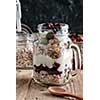 Healthy breakfast with Homemade granola. Muesli, fresh berries and yogurt in glass mason jar on wooden table. 