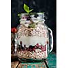 Muesli, fresh berries and yogurt in glass mason jar on wooden table. Healthy breakfast with Homemade granola