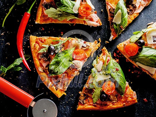 Cut into slices delicious fresh pizza with mushrooms, tomatoes, basil and bacon on a dark background. Top view . Pizza on the black table.
Cut into slices delicious fresh pizza with mushrooms, tomatoes, basil and bacon on a dark background. Top view . Pizza on the black table.