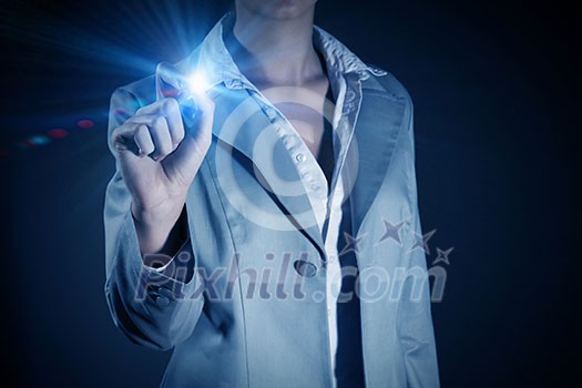 Businesswoman touching light button on blue screen Businesswoman touching light button on blue screen