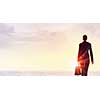 Rear view of businesswoman looking at sunset above city