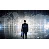 Back view of businessman with suitcase in hands looking at virtual panel