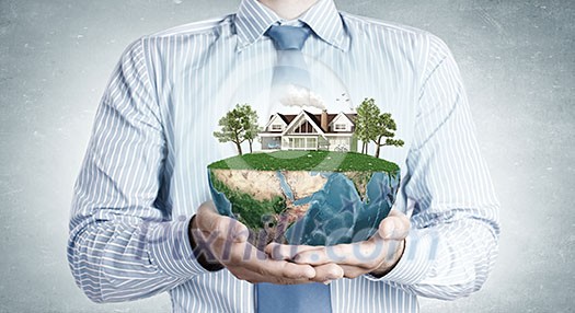 Close up of hands presenting model of green countryside life. Elements of this image are furnished by NASA Close up of hands presenting model of green countryside life. Elements of this image are furnished by NASA