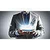 Close up of businessman holding clear blue water in palms