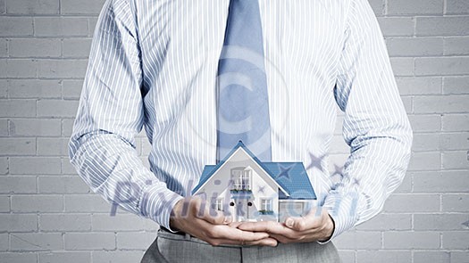 Close up of businessman holding house model in hands Close up of businessman holding house model in hands