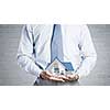 Close up of businessman holding house model in hands