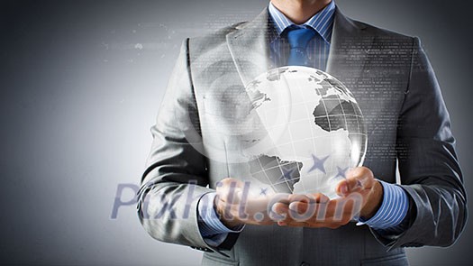 Close up of businessman holding digital globe in palm Close up of businessman holding digital globe in palm