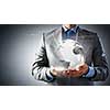 Close up of businessman holding digital globe in palm