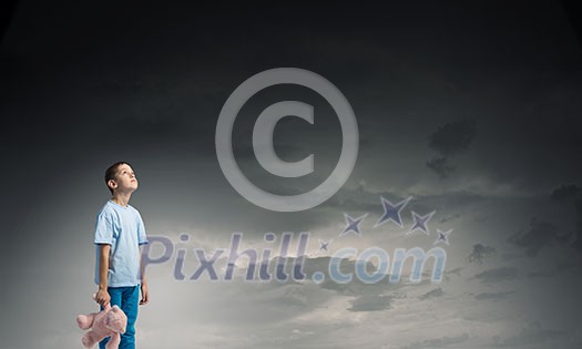 Cute little boy with toy bear in night darkness Cute little boy with toy bear in night darkness