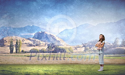 Cute girl wearing pajamas with toy bear in hand outdoors Cute girl wearing pajamas with toy bear in hand outdoors
