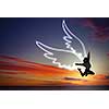 Young girl with drawn wings jumping high in sky