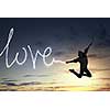 Young girl jumping high in sky and drawing love word