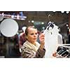 Young woman shopping in a fashion store (color toned image; shallow DOF)