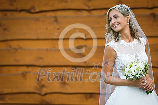 Gorgeous bride on her wedding day holding her lovely bouquet (color toned image; shallow DOF) Gorgeous bride on her wedding day holding her lovely bouquet (color toned image; shallow DOF)